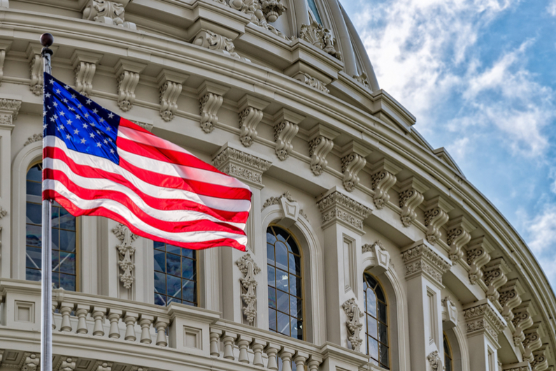 Washington DC Capitol dome detail with waving American flag