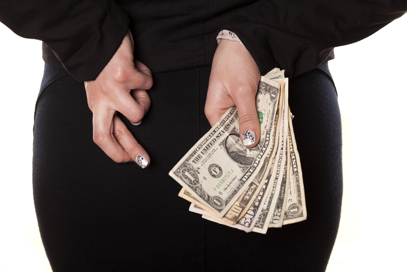 female crossing her fingers and holding money behind her back