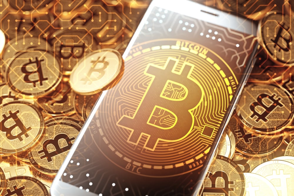 Bitcoin sign on smartphone surrounded by bitcoins