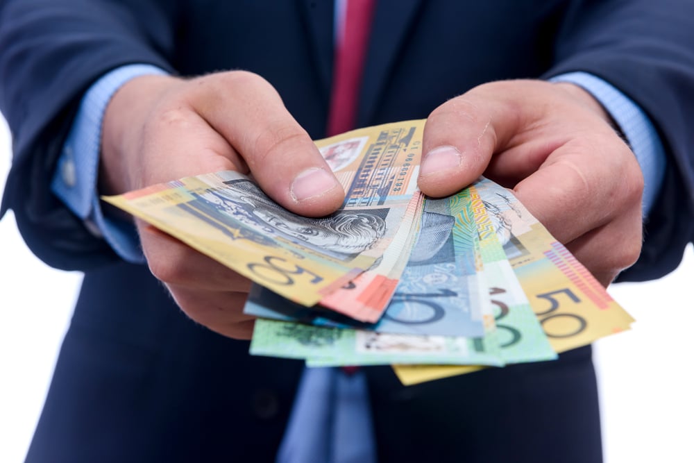 Businessman offering Australian bank notes